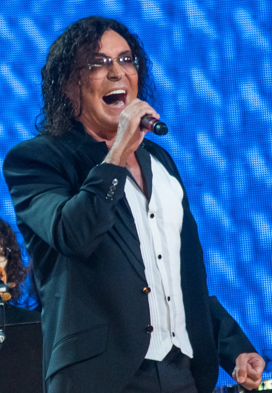 Valery Leontiev singing on stage at Laima Rendez Vous Jurmala 2017, holding a microphone in front of a blue lit backgrou