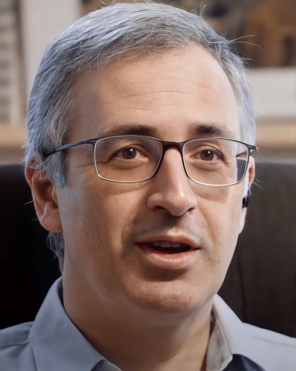 Portrait photo of Sergei Guriev wearing glasses