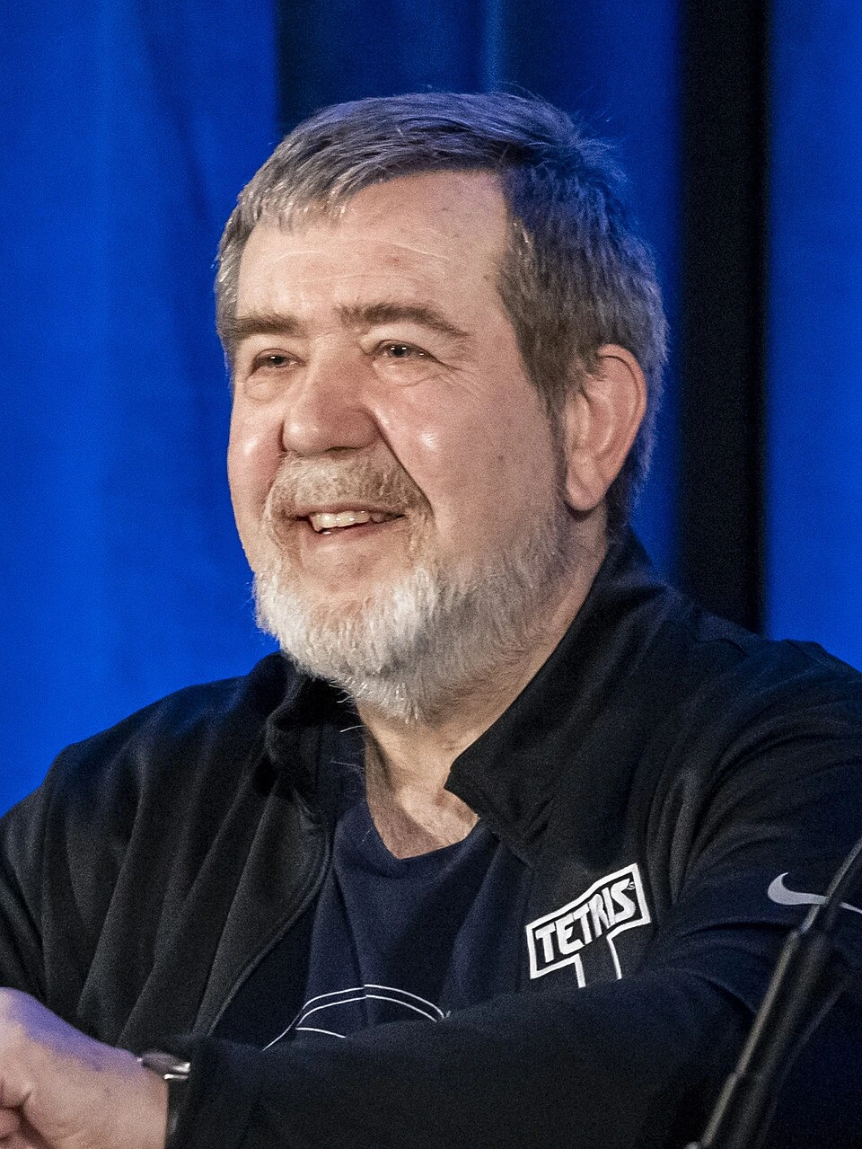 Alexey Pajitnov smiling on stage at a conference