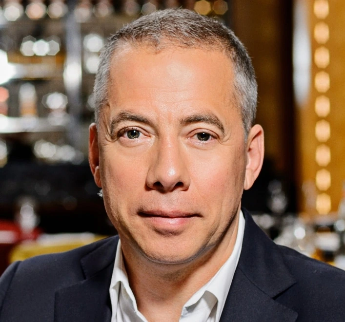 Portrait of Arkady Novikov in a restaurant setting.